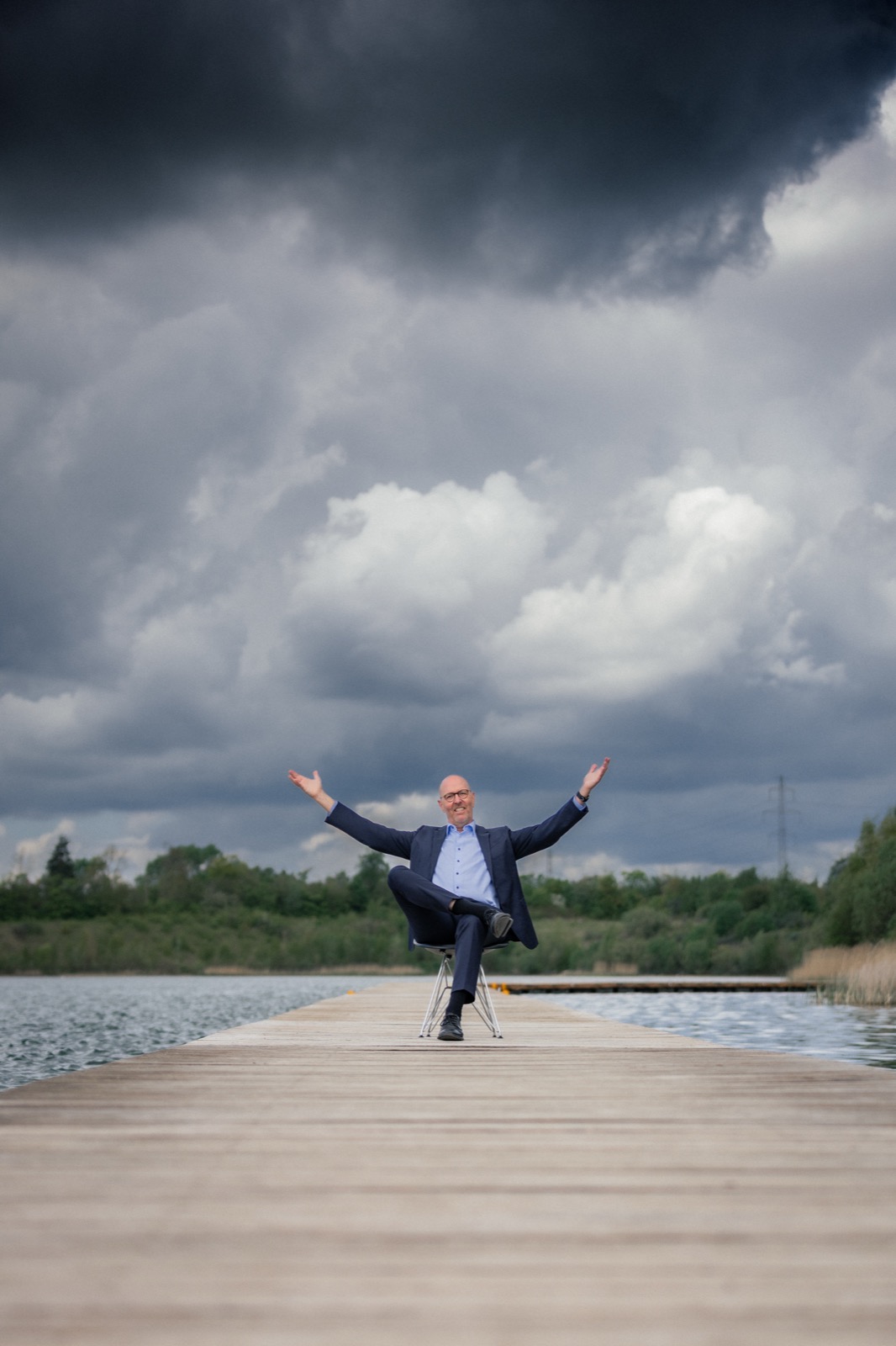 Per Beining with arms flung wide under a huge dramatic sky